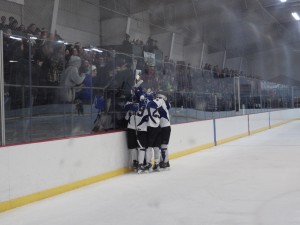 The Blue Streaks celebrate after Elliott Hungerford's second period goal, the first of the game.