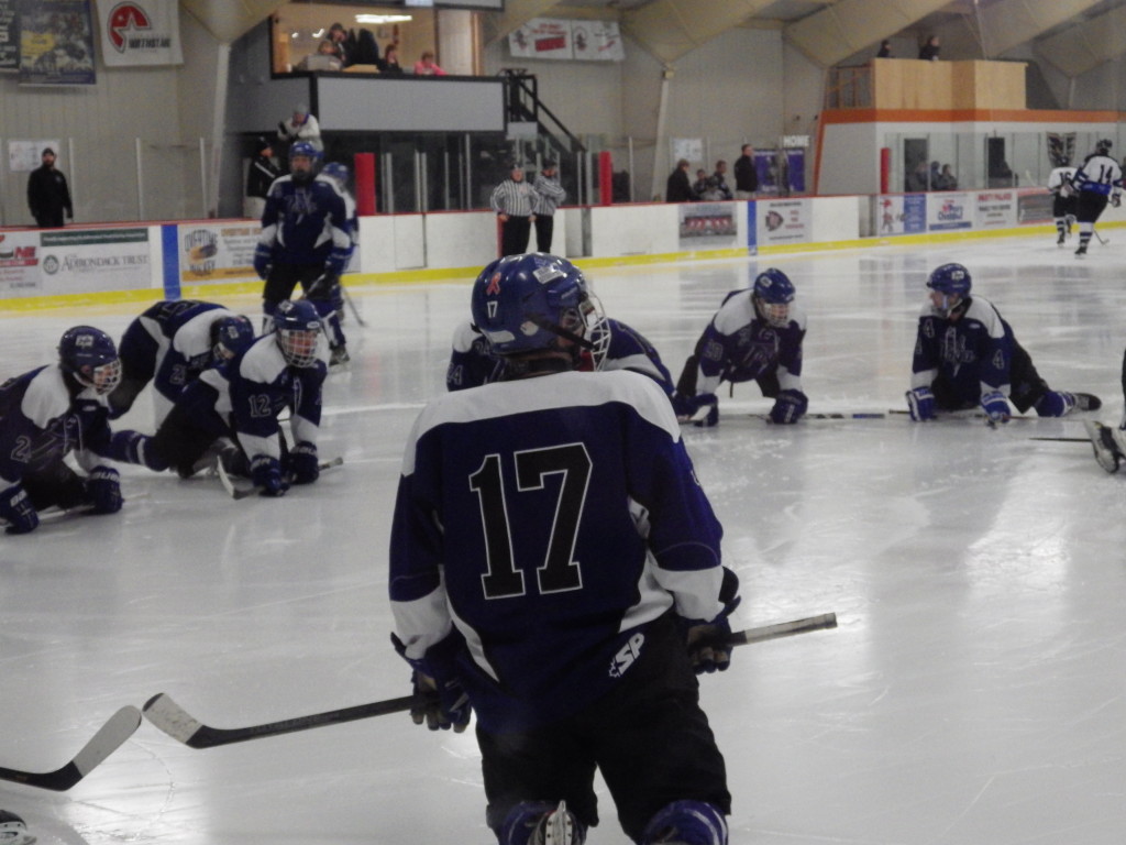 Saratoga's Grayson Rieder '14 joins the team in stretching before the third period began. At this point, the team was tied 2-2 against the Rivermen, and each team would add one goal in the third period.