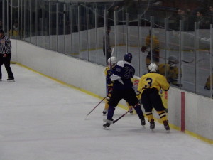 Saratoga defenseman Brendan Coffey '16 makes a pass up the ice during the game against Pelham.