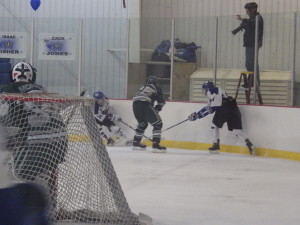 Shen's Cameron Kuhl '16, center, is caught between Saratoga forwards Jack Rittenhouse '15 and Drew Patterson '14 during the second period.