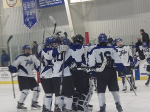 The Blue Streaks celebrate after winning the Friday semifinal against La Salle to advance to the sectional final.
